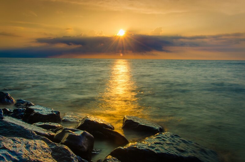Sun Setting over Ocean — Gold, Serene, Sunset, Photograph, Rocks