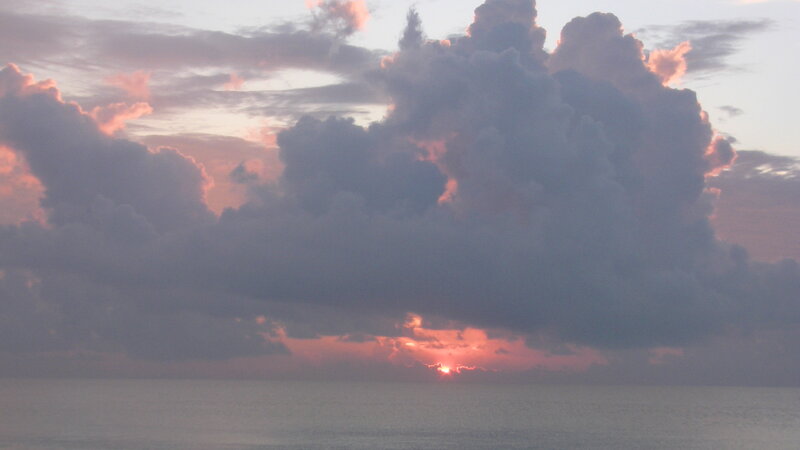 Sun Setting over Ocean — Gray, Dramatic