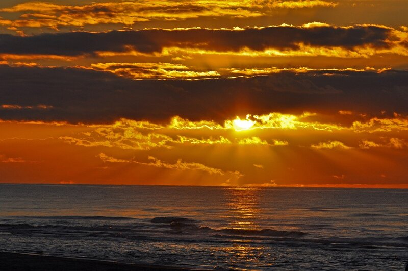 Sun Setting over Ocean — Orange, Dramatic, Sunset, Photograph, Clouds, Beach, Yellow