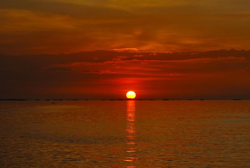 Sun Setting over Ocean — Orange, Dramatic, Sunset, Photograph, Clouds, Boats