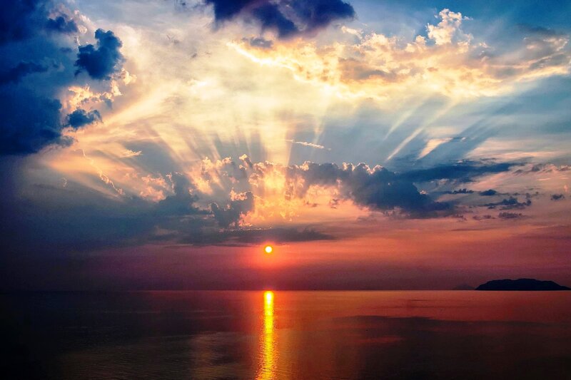 Sun Setting over Ocean — Orange, Dramatic, Sunset, Photograph, Clouds, Reflection, Island