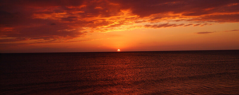 Sun Setting over Ocean — Orange, Red