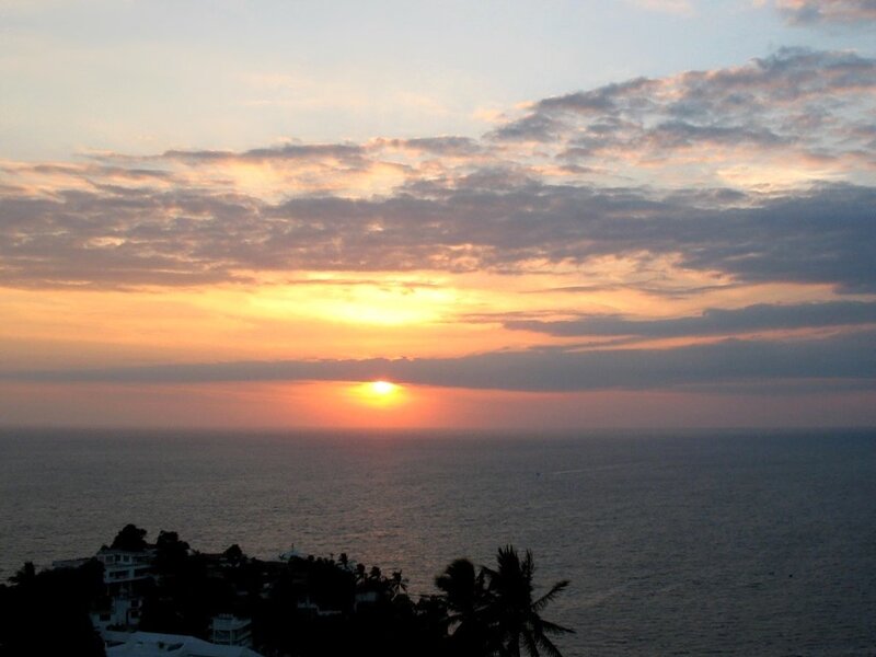 Sun Setting over Ocean — Orange, Serene, Sunset, Photograph, Clouds, Buildings