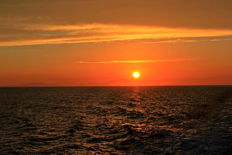 Sun Setting over Ocean — Orange, Serene, Sunset, Photograph, Clouds, Mountains
