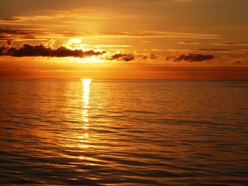 Sun Setting over Ocean — Orange, Serene, Sunset, Photograph, Clouds, Reflection, Yellow, Brown