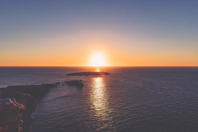 Sun Setting over Ocean — Orange, Serene, Sunset, Photograph, Island, Cliff