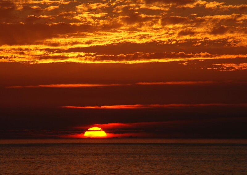 Sun Setting over Ocean — Photograph, Red