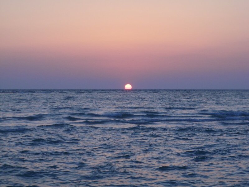 Sun Setting over Ocean — Pink