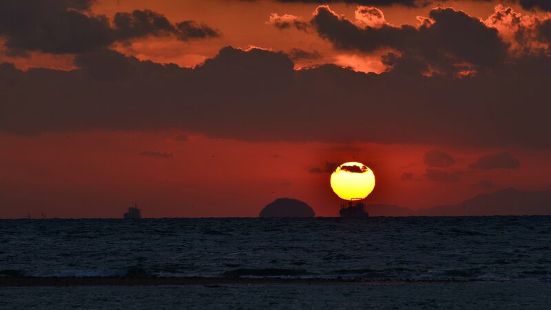 Sun Setting over Ocean — Red, Dramatic, Sunset, Photograph, Ship, Clouds