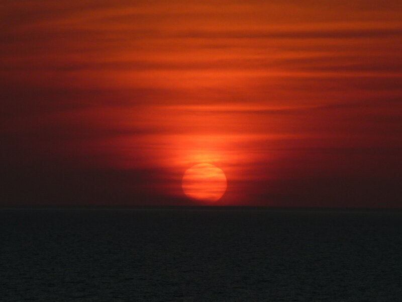 Sun Setting over Ocean — Red, Dramatic, Sunset, Photograph, Sky, Clouds