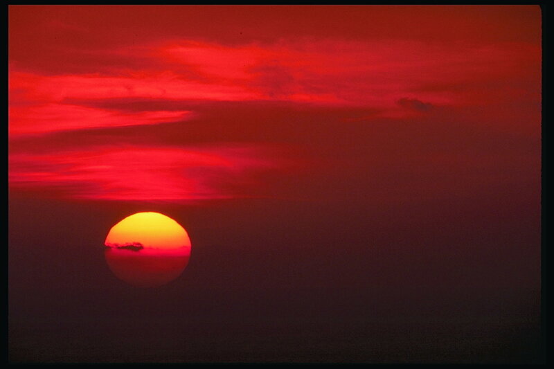 Sun Setting over Ocean — Red, Photograph