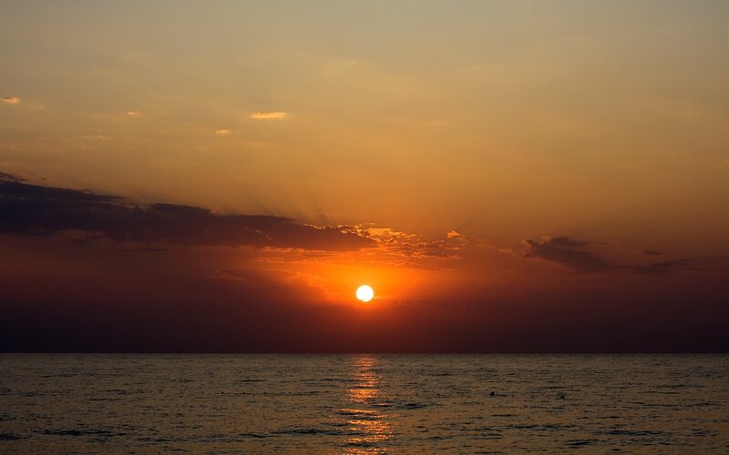 Sun Setting over Ocean — Serene, Clouds