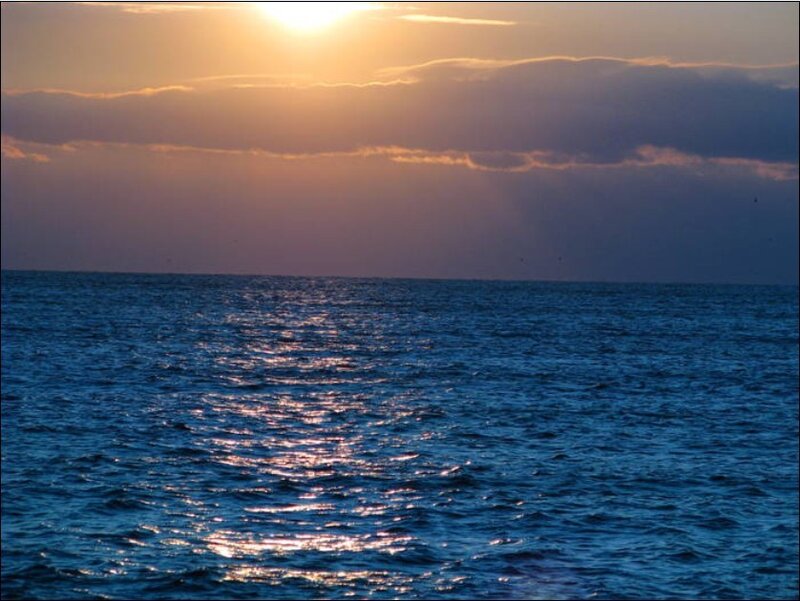 Sun Setting over Ocean — Serene, Orange
