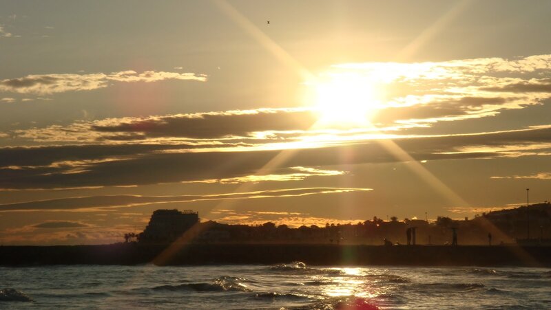 Sun Setting over Ocean — Yellow, Serene, Sunset, Photograph, Clouds, Building