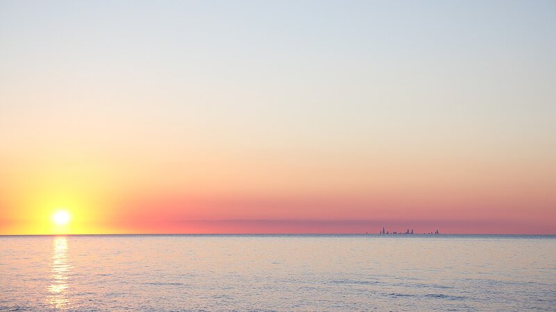 Sun Setting over Ocean — Yellow, Serene, Sunset, Photograph, Horizon, City Skyline