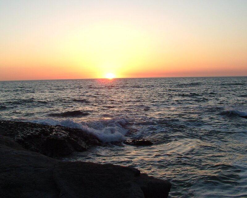 Sun Setting over Ocean — Yellow, Serene, Sunset, Photograph, Rocks, Sky