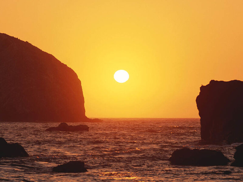 Sun Setting over Ocean — Yellow, Serene, Sunset, Photograph, Rocks