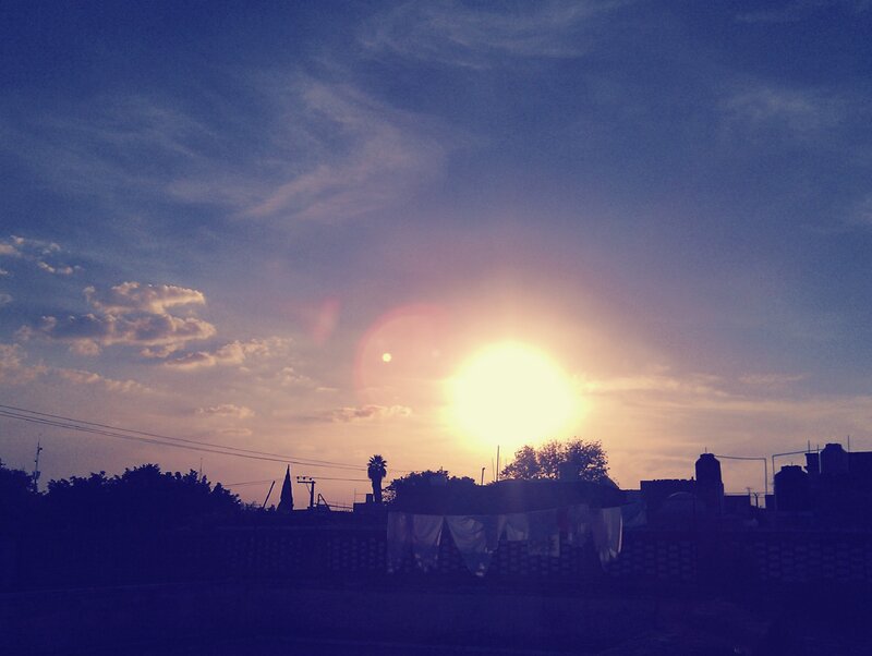 Sun Setting over Rooftops — Blue