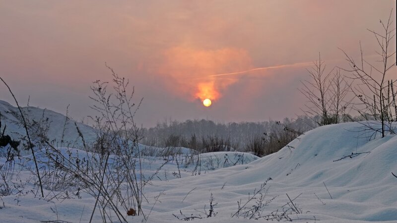 Sun Setting over Snowy Landscape