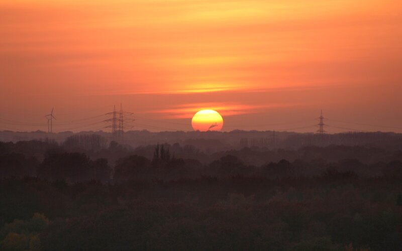 Sun Setting over Trees — Orange, Serene, Sunset, Photograph, Wind Turbine