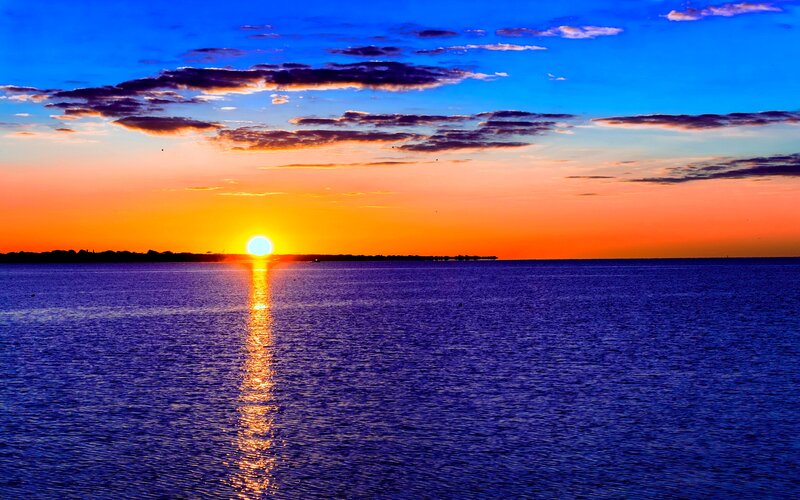Sun Setting over Water — Blue, Dramatic, Sunset
