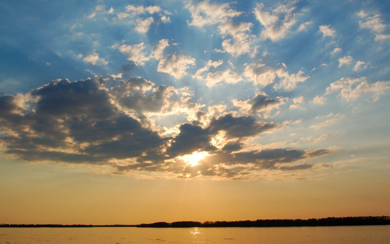 Sun Setting over Water — Blue, Serene, Sunset, Photograph, Clouds, Sky