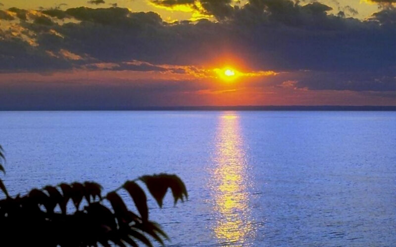 Sun Setting over Water — Blue, Serene, Sunset, Photograph, Clouds
