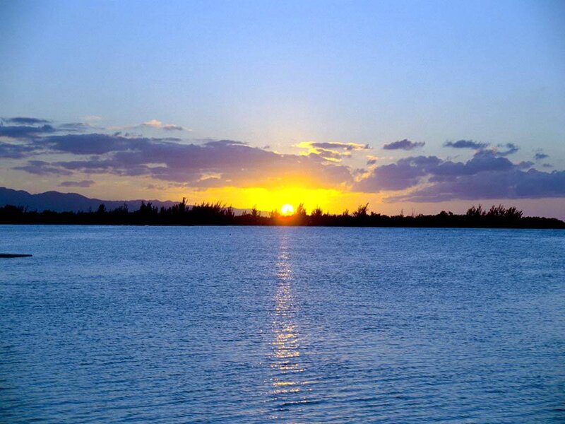 Sun Setting over Water — Blue, Serene, Sunset, Photograph, Mountains