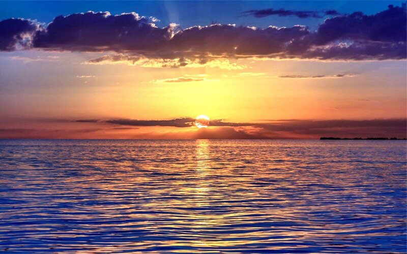 Sun Setting over Water — Blue, Serene, Sunset