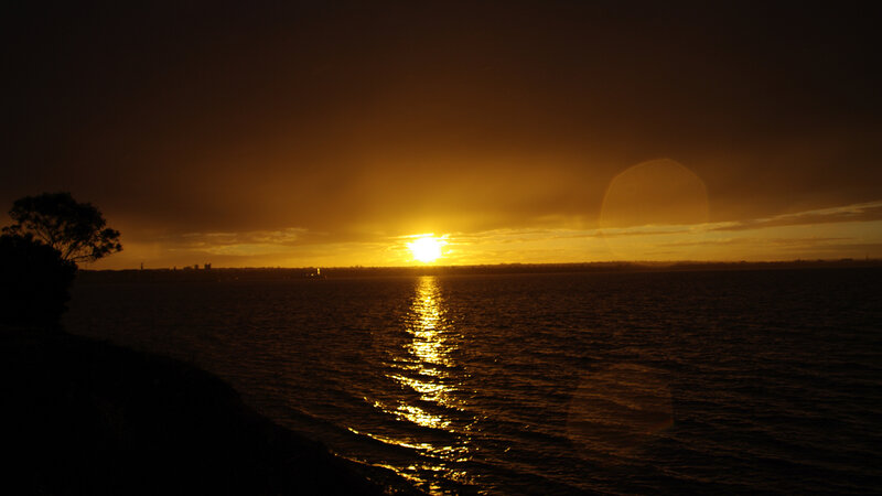 Sun Setting over Water — Gold, Dramatic, Sunset