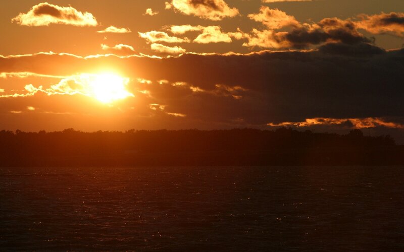 Sun Setting over Water — Orange, Dramatic, Sunset, Photograph, Clouds, Trees