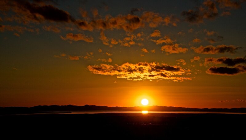 Sun Setting over Water — Orange, Dramatic, Sunset, Photograph, Mountains