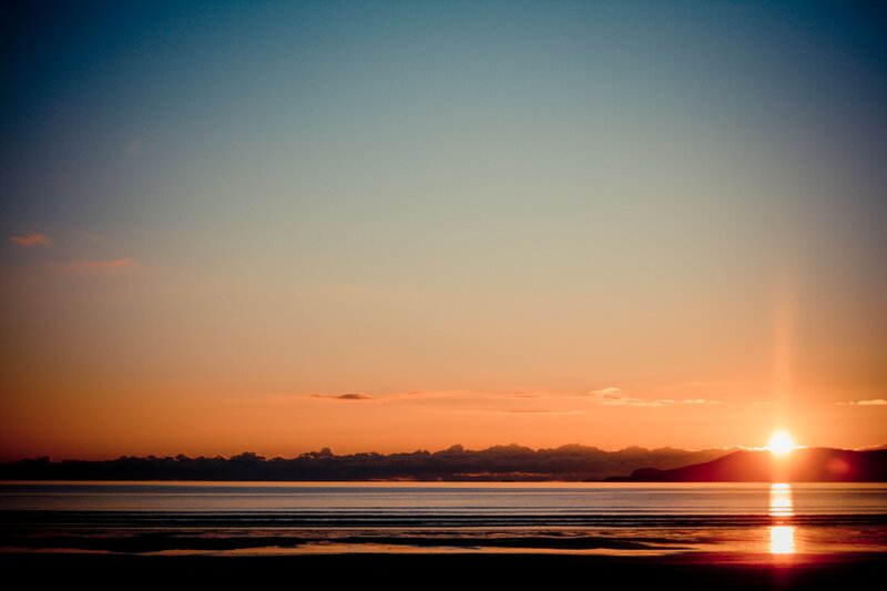 Sun Setting over Water — Orange, Serene, Sunset, Photograph, Mountains, Sky, Reflection