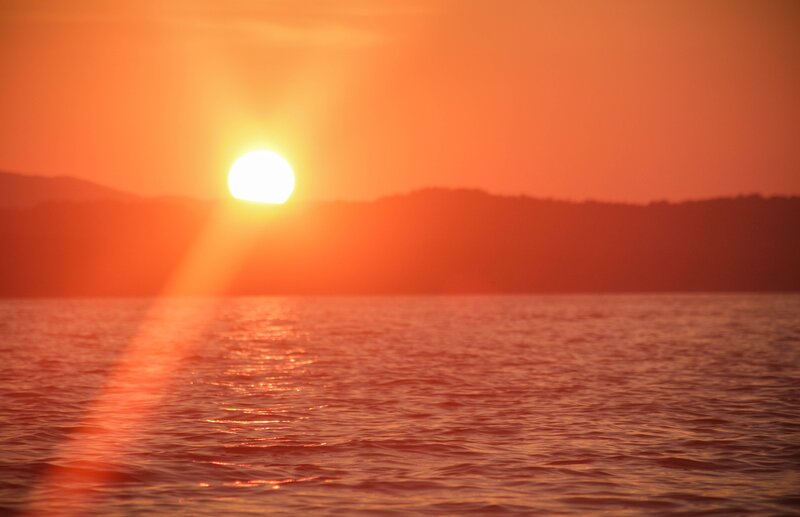 Sun Setting over Water — Orange, Serene, Sunset, Photograph, Mountains, Sky