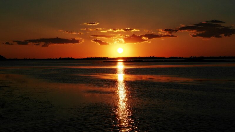 Sun Setting over Water — Orange, Serene, Sunset, Photograph, Sky, Clouds