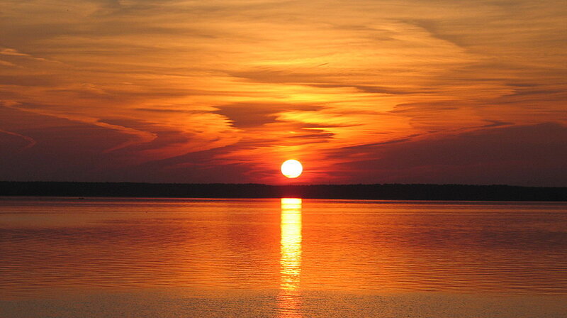 Sun Setting over Water — Orange, Serene, Sunset, Photograph, Sky, Trees