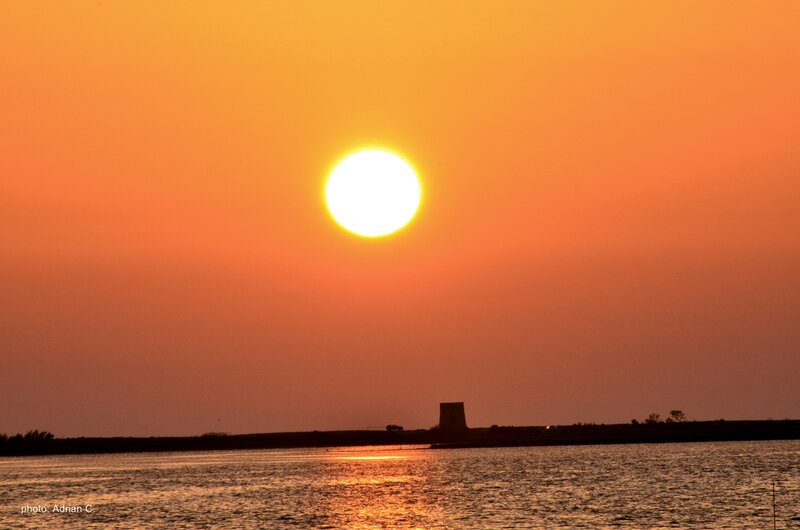 Sun Setting over Water — Orange, Serene, Sunset, Photograph, Tower