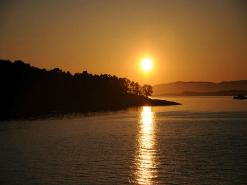 Sun Setting over Water — Orange, Serene, Sunset, Photograph, Trees, Mountains