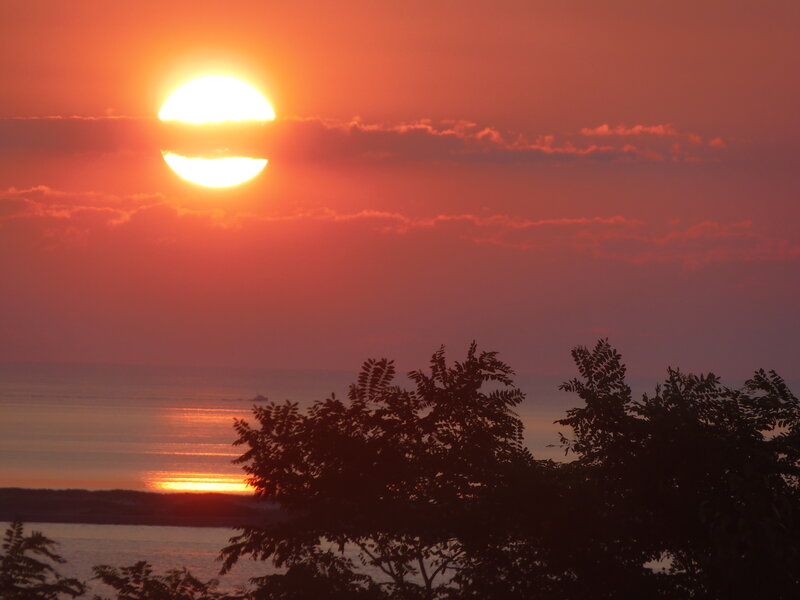 Sun Setting over Water — Orange, Serene, Sunset, Photograph, Trees