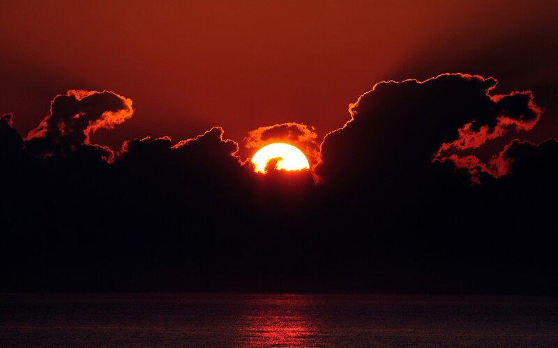 Sun Setting over Water — Red, Dramatic, Sunset, Photograph, Clouds, Ocean, Black