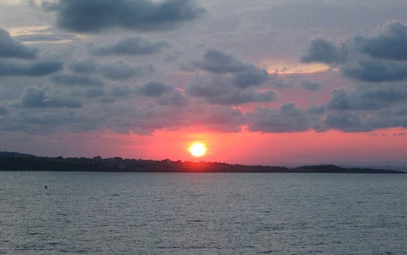 Sun Setting over Water — Red, Serene, Sunset