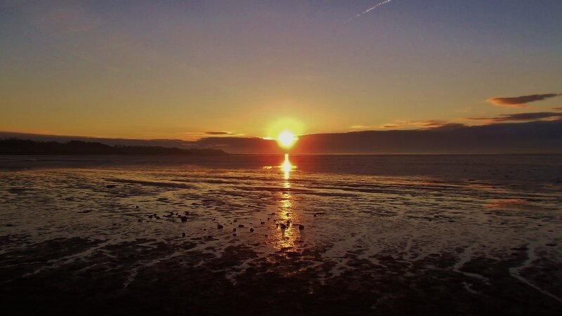 Sun Setting over Wet Beach