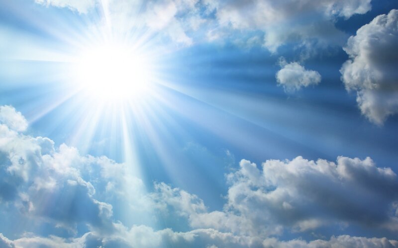 Sun Shining Through Clouds — Photograph