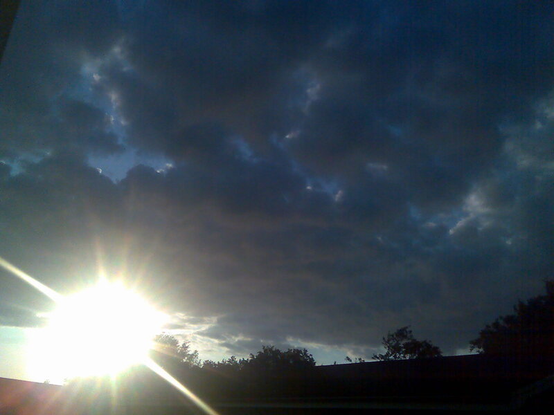 Sun shining through dark clouds