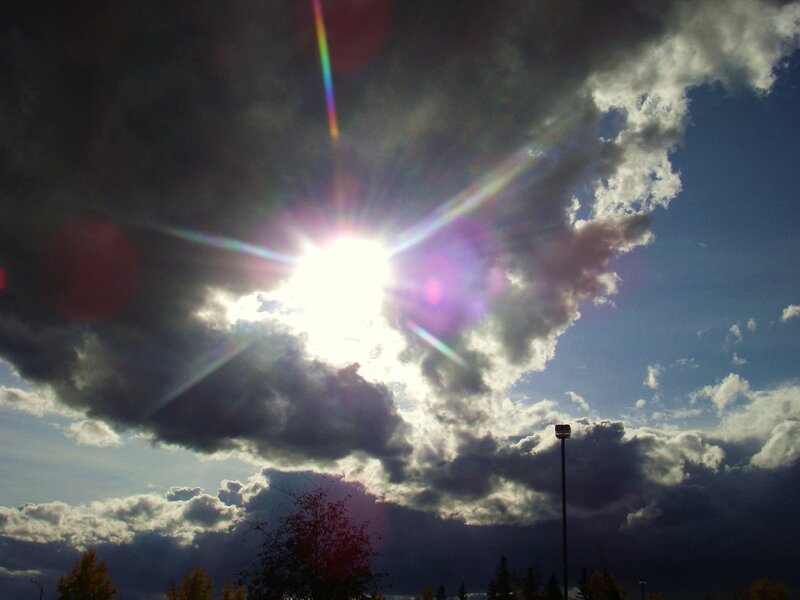 Sun shining through storm clouds
