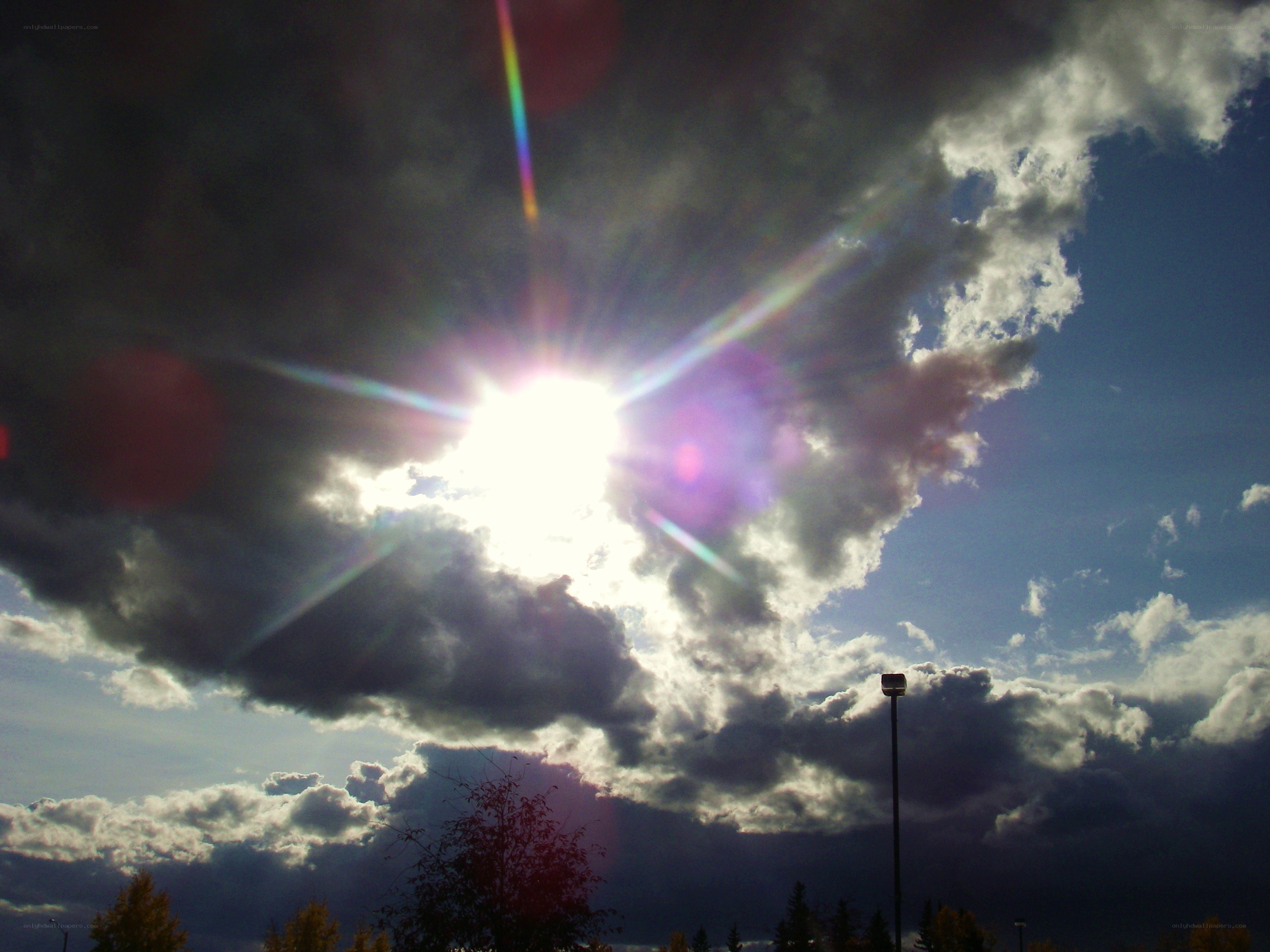 Sun shining through storm clouds