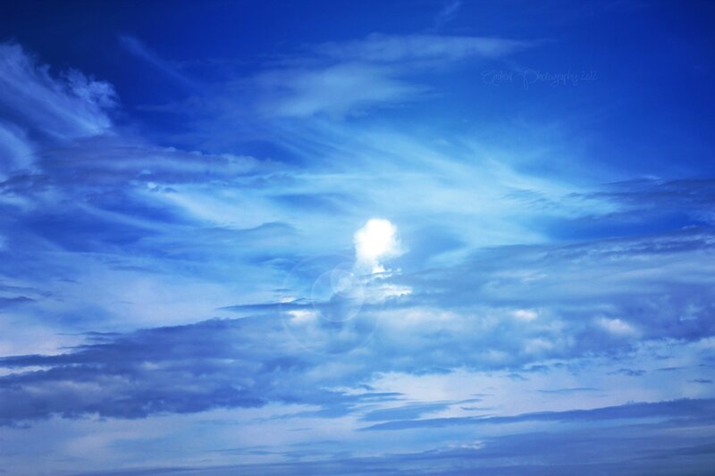 Sun Through Blue Clouds