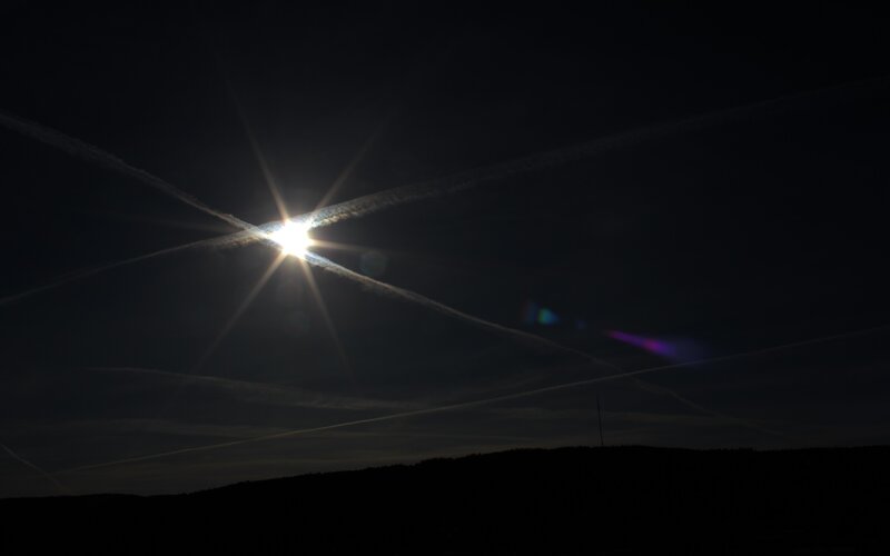 Sun with contrails at dusk