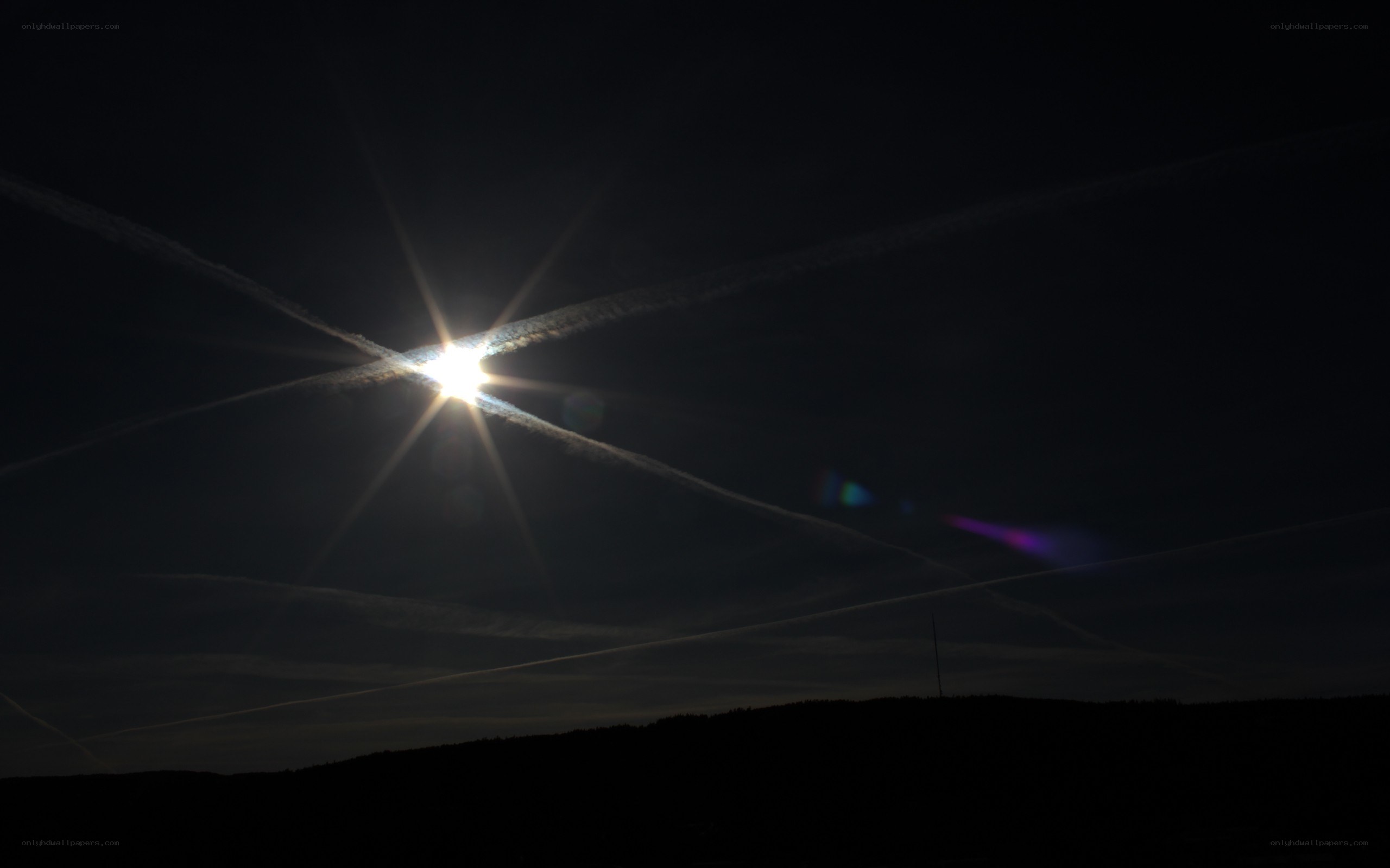 Sun with contrails at dusk