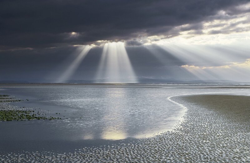 Sunbeams over a tidal flat